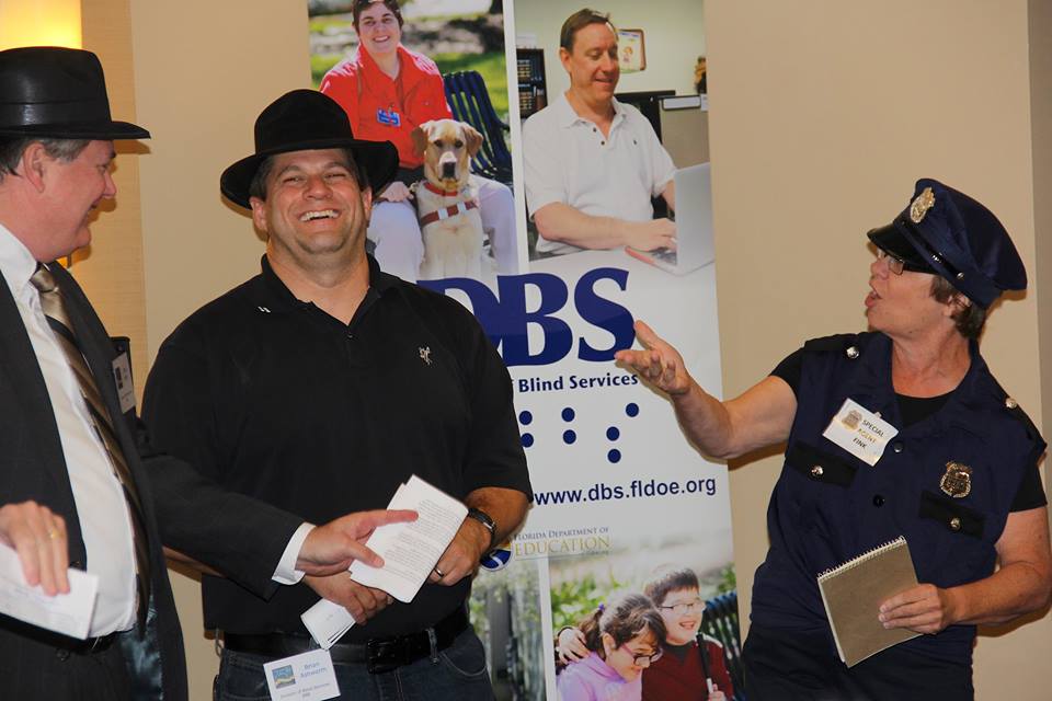 Three staff members from the BBE program laugh as they perform a skit during the 75th anniversary ceremony and expo.